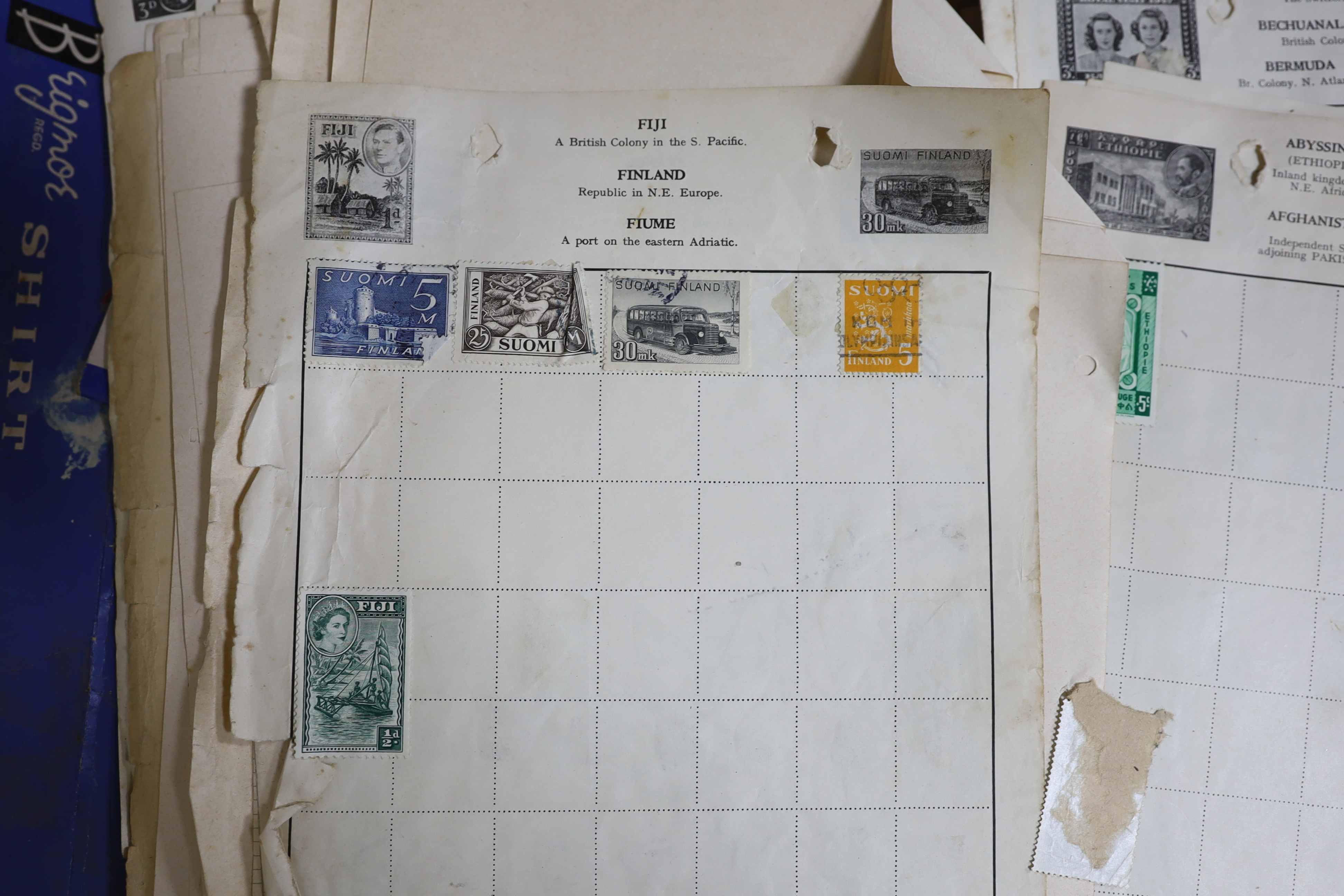 A collection of world stamps, some arranged in albums